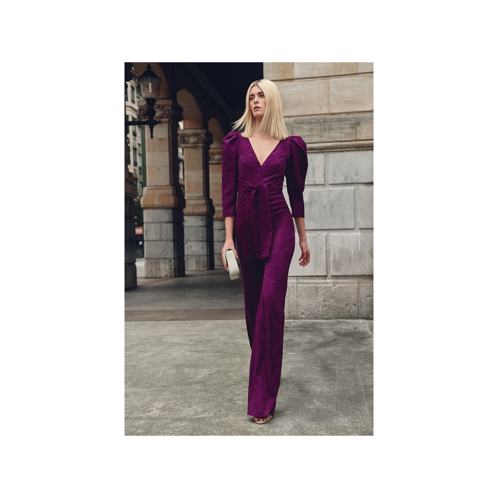 Mono de fiesta morado con manga abullonada y lazada para invitadas